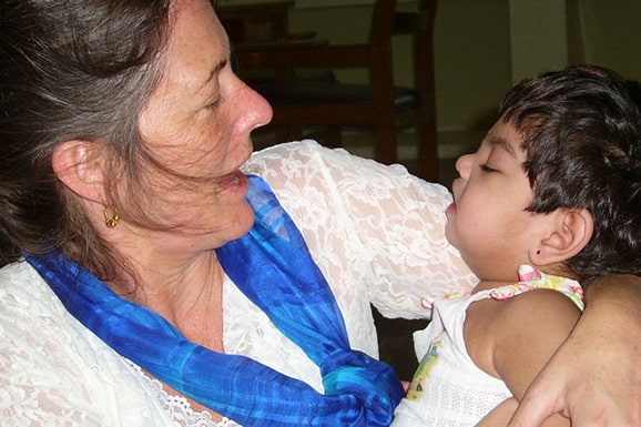 Dr. Linda lawrence, an advisor with Chetana’s Icount project turns her head towards the child in her arms.