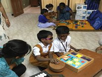 Children with vision impairment playing a tactile and accessible game.