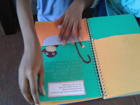 A young boy explores the picture of a monkey in an accessible tactile story book.